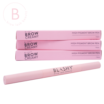 Ein rosafarbener BLASHY BROW CREAMY Augenbrauen Stift steht vor drei gestapelten Blashy Produktboxen. Blashy Shop